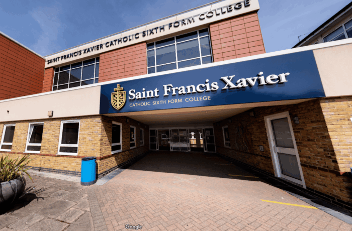 Front entrance of Saint Francis Xavier Catholic Sixth Form College, with the college's name and crest displayed above the covered walkway.