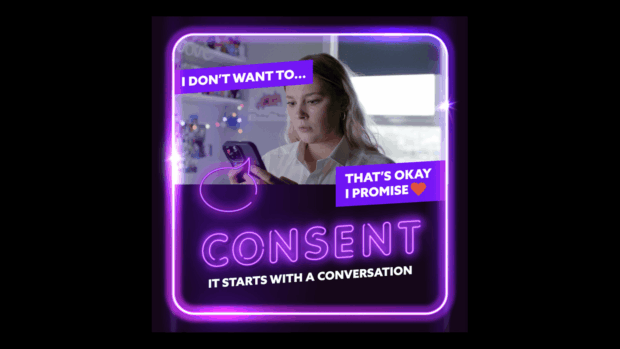 A young woman looking at her phone, framed by a purple neon border, with caption text 'I don't want to... That's okay, I promise' with a heart emoji, and the neon text 'Consent: it starts with a conversation.
