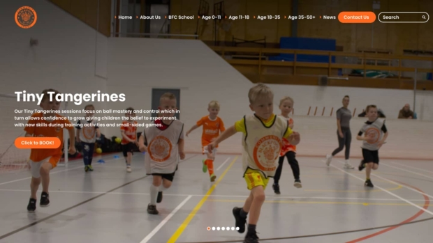 Screenshot of the Blackpool FC Community Trust website 'Tiny Tangerines' page, showing young children playing football in a sports hall, with heading 'Tiny Tangerines', a description of the sessions, and a 'Click to BOOK!' button.