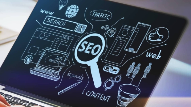 Laptop screen showing a hand-drawn SEO concept diagram with icons for search, traffic, keywords, content, site architecture, and web analytics.